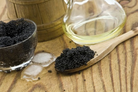 Black caviar on wood table closeup